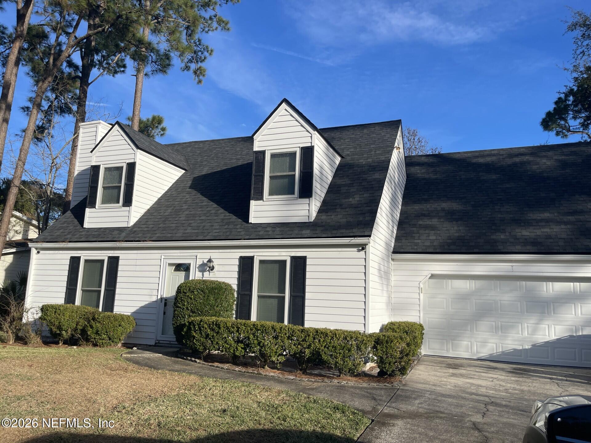 1077 Kings Road Neptune Beach, FL 32266 - Photo 2 of 2 a front view of a house with a yard