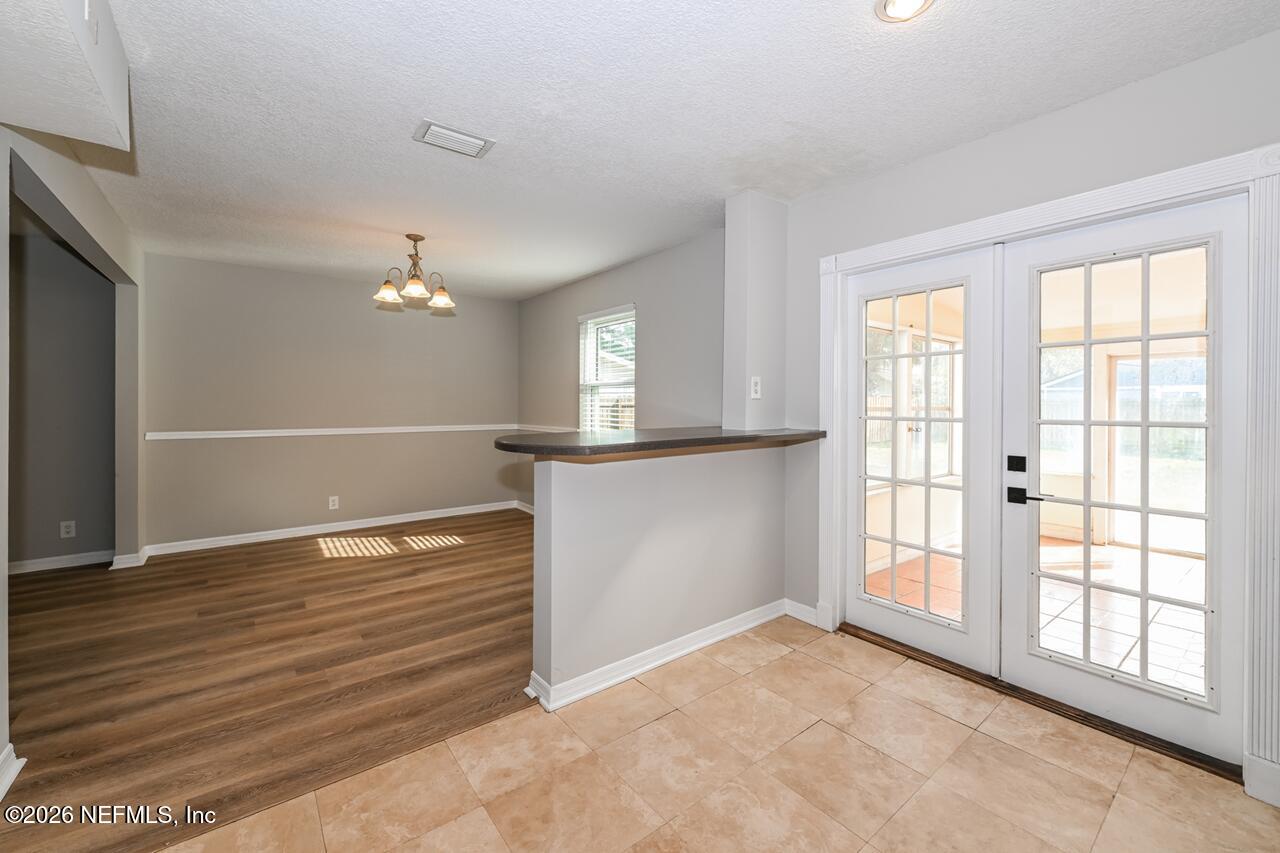 1077 Kings Road Neptune Beach, FL 32266 - Photo 4 of 19 a view of an empty room with window and wooden floor