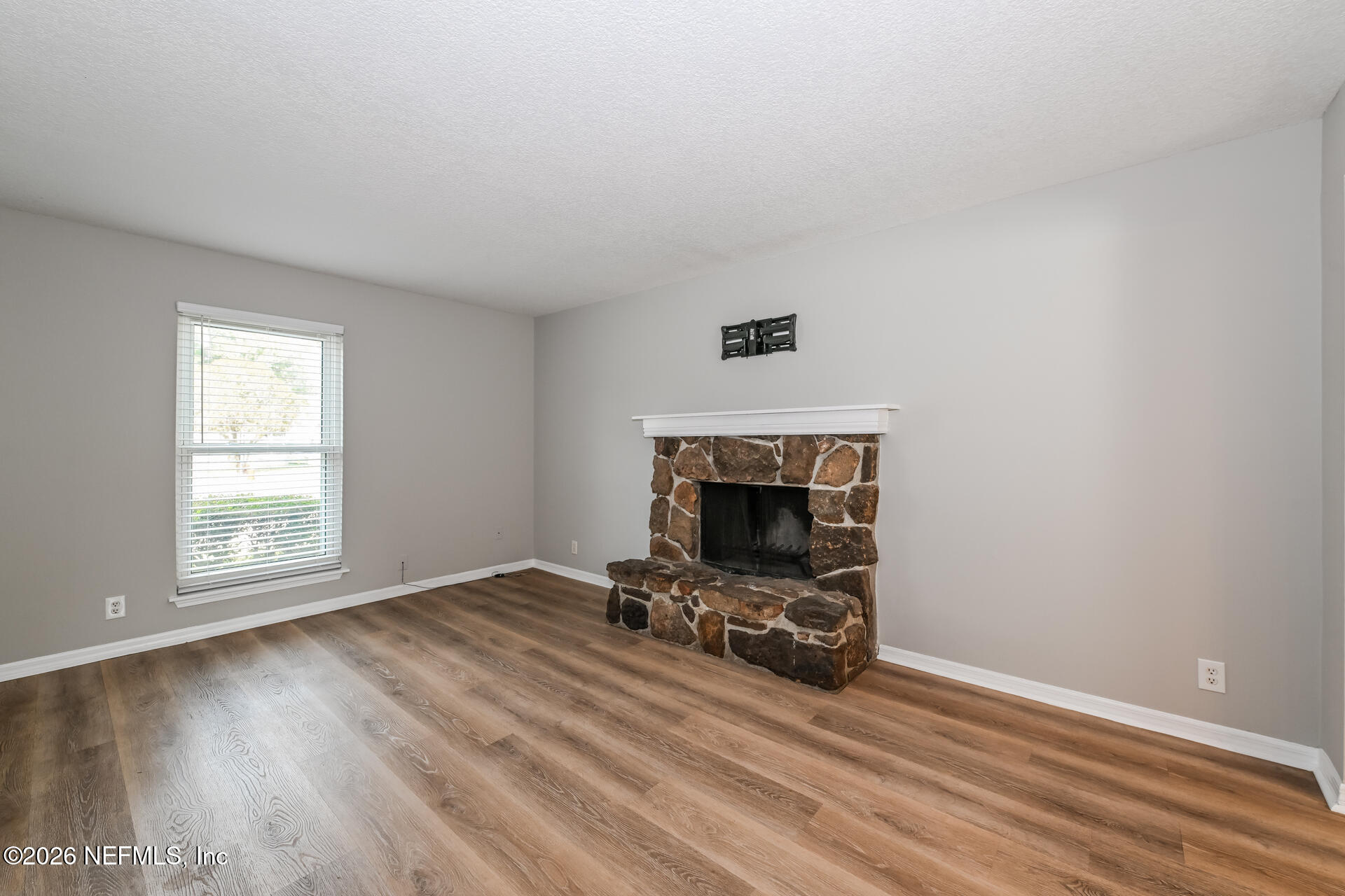 1077 Kings Road Neptune Beach, FL 32266 - Photo 5 of 19 an empty room with a fireplace and window
