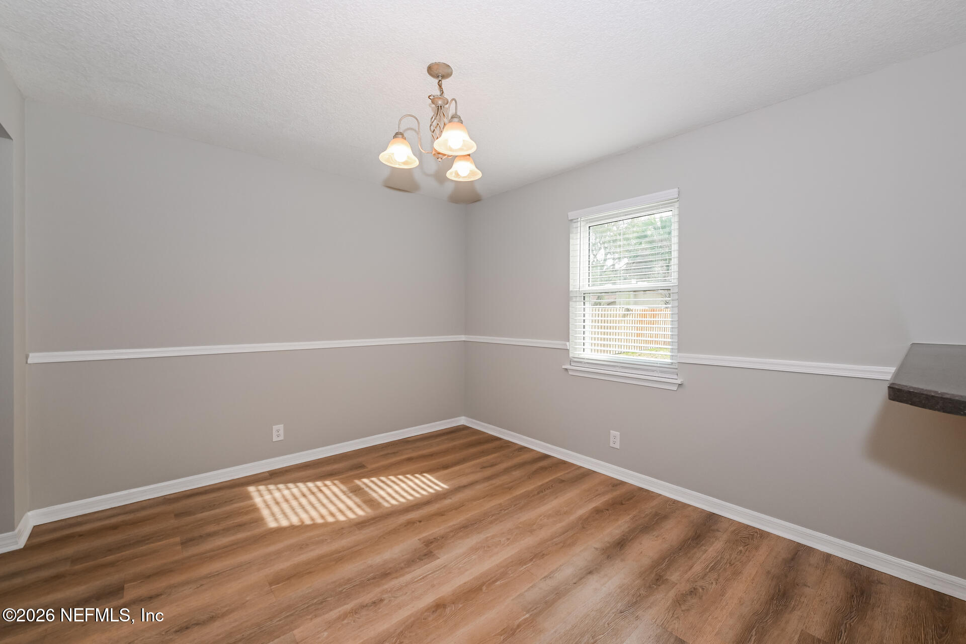 1077 Kings Road Neptune Beach, FL 32266 - Photo 8 of 19 an empty room with wooden floor and windows