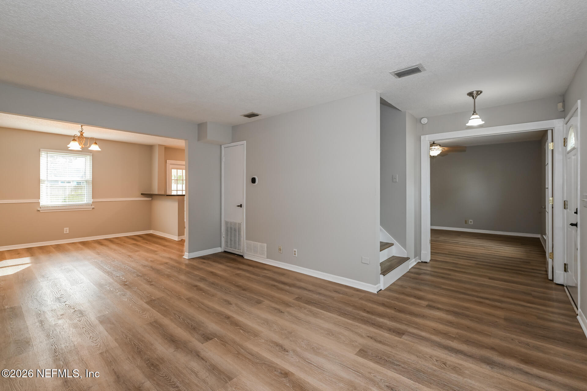 1077 Kings Road Neptune Beach, FL 32266 - Photo 10 of 19 an empty room with wooden floor and windows