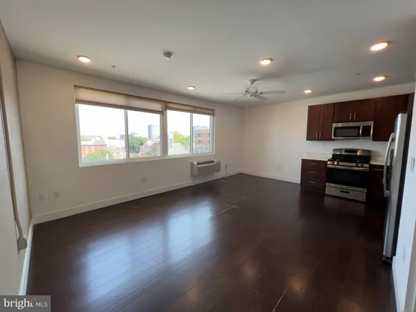 a living room with hard wood floors and a wooden floor