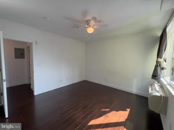 a view of wooden floor and windows in a room