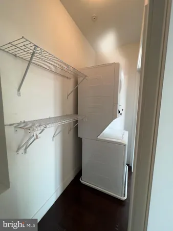 a view of walk in closet with wooden floor