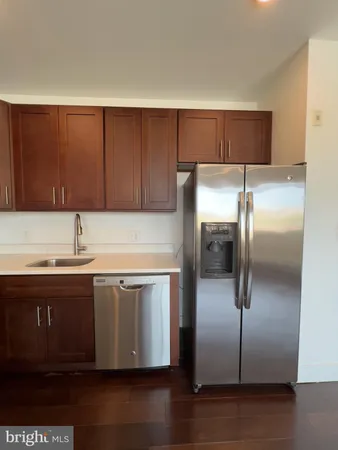 a kitchen with kitchen island a sink and refrigerator