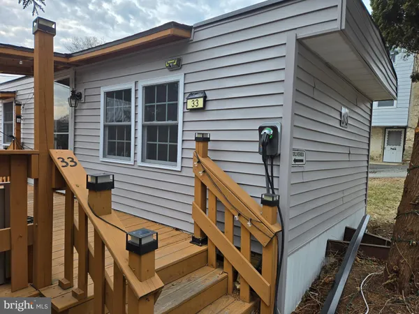 a front view of a house with street and windows