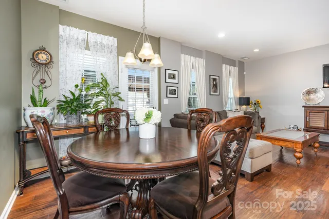 a view of a dining room with furniture and chandelier