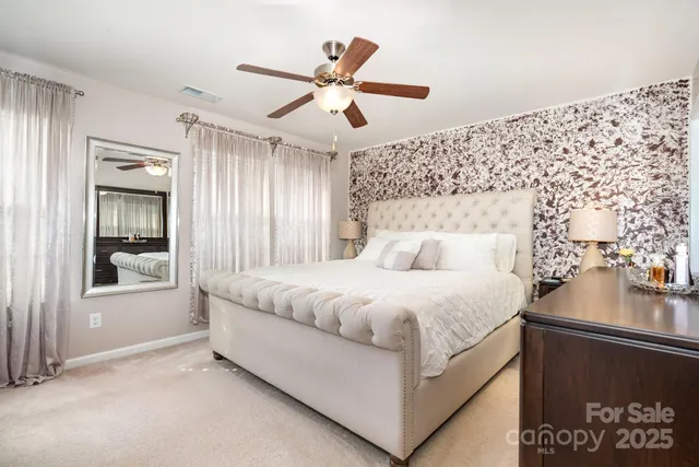 a spacious bedroom with a bed and window