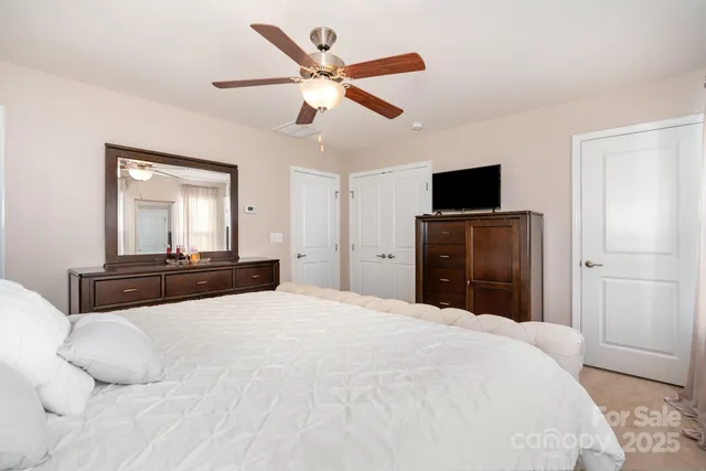 a bedroom with a large bed and a flat screen tv