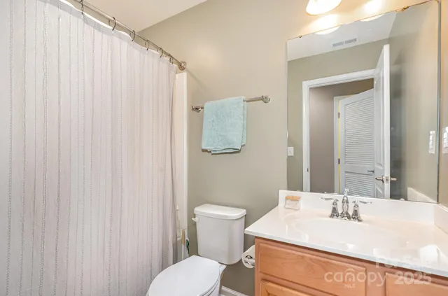 a bathroom with a sink a toilet and mirror