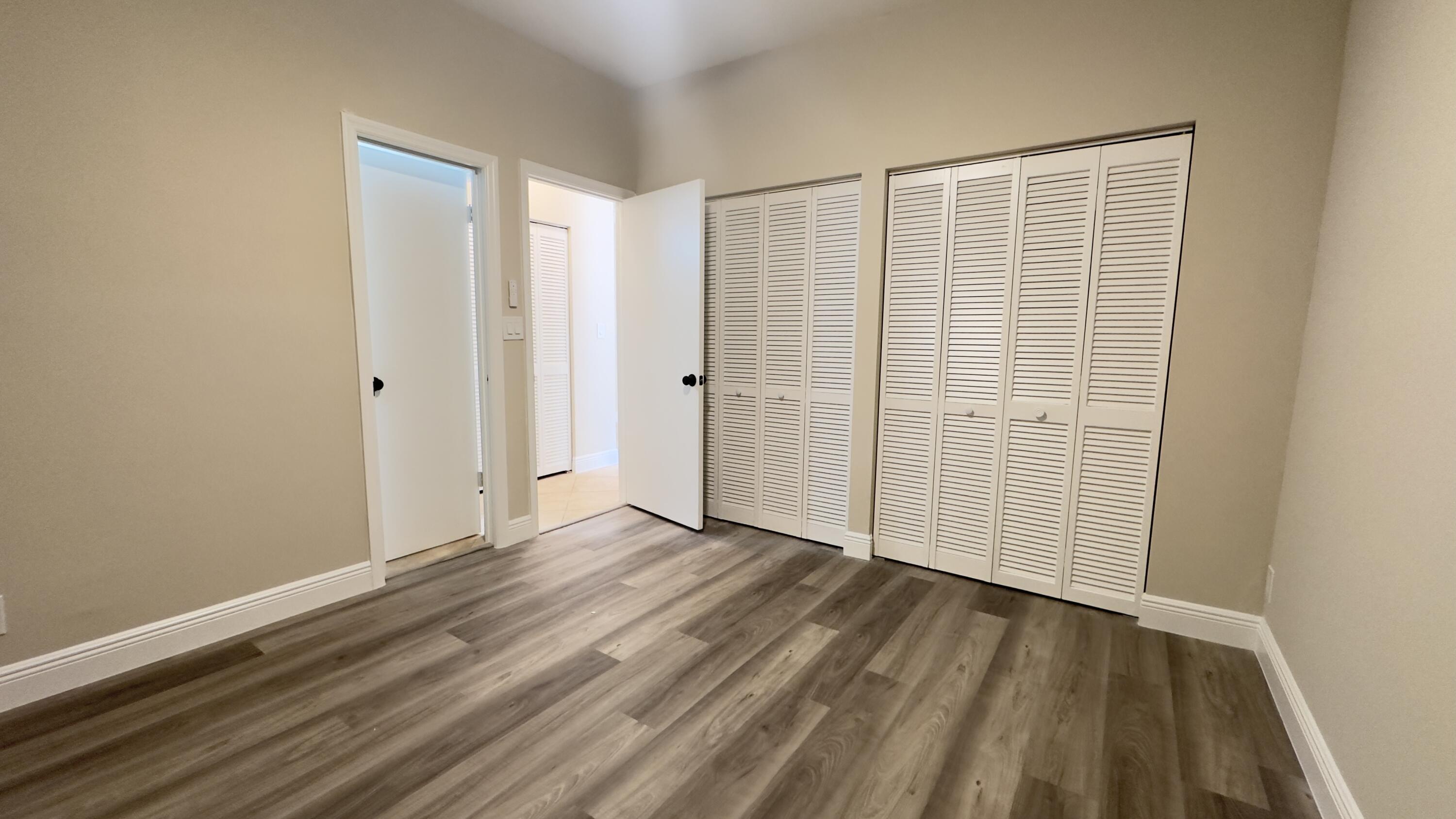 11330 Timber Lodge Terrace Boca Raton, FL 33428 - Photo 9 of 23 a view of an empty room with wooden floor