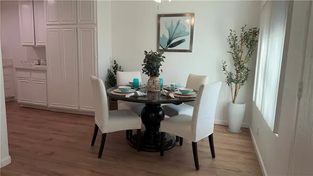 a dining room with furniture and wooden floor