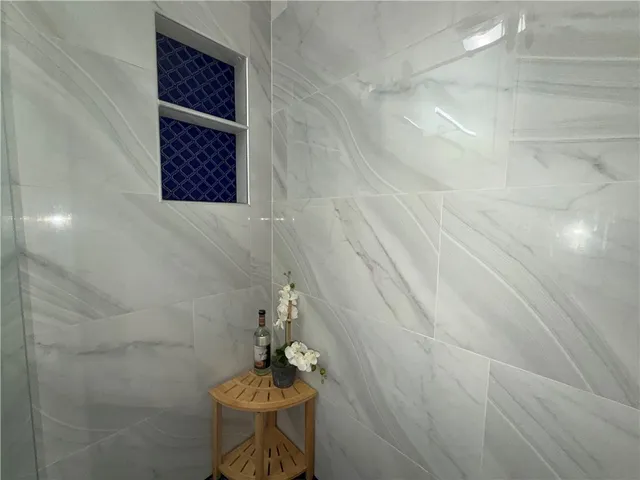 a bathroom with a shower and a sink