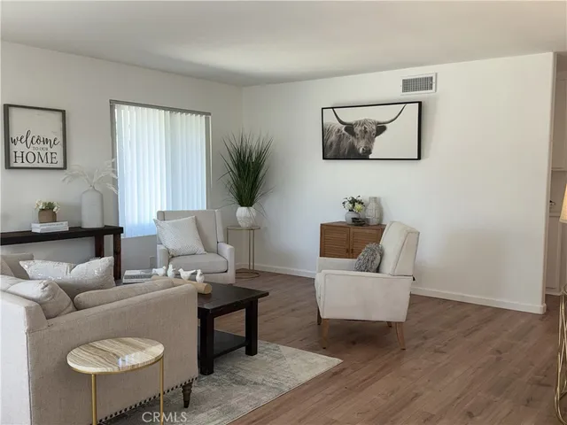 a living room with furniture and a potted plant