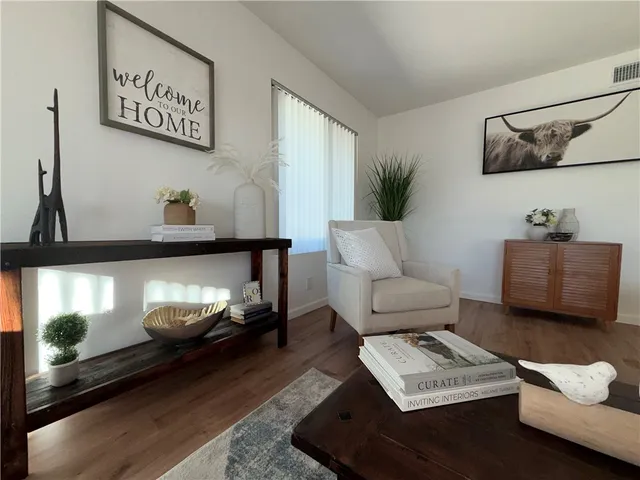 a living room with furniture and a potted plant
