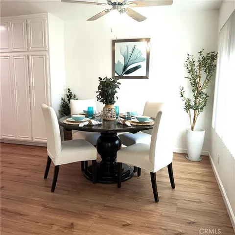 a dining room with furniture and wooden floor