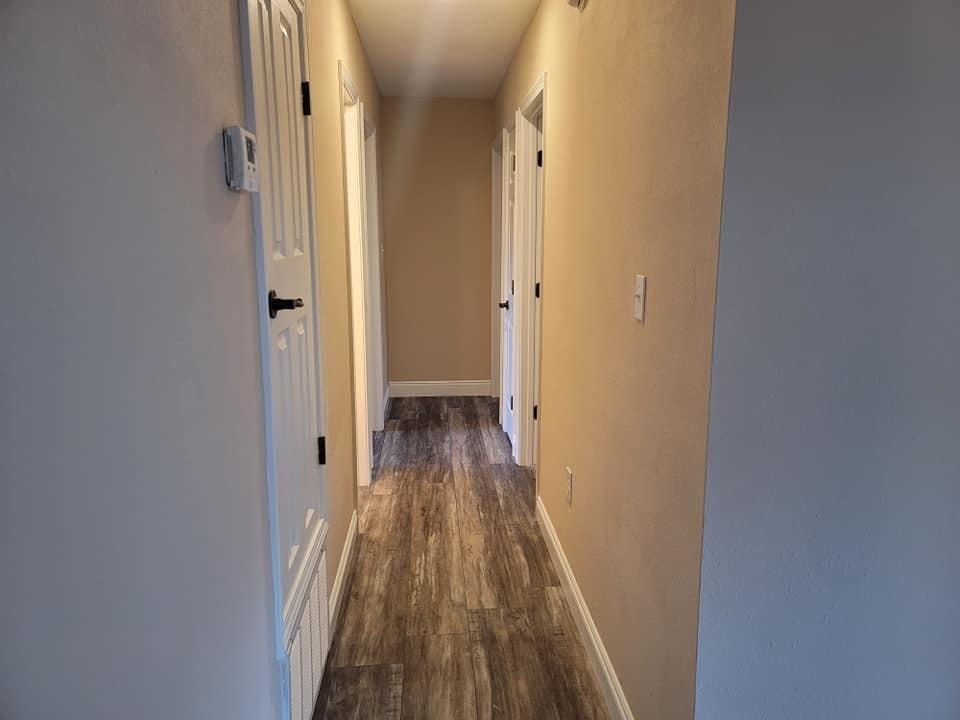 3526 Auburn Road Crestview, FL 32539 - Photo 5 of 11 a view of a hallway with wooden floor and a bathroom
