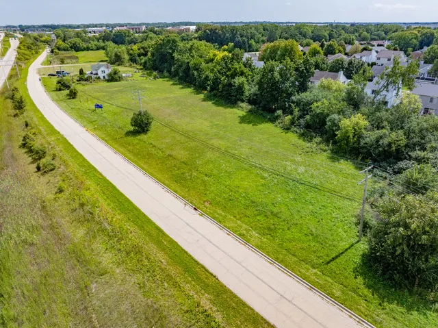 a view of a swimming pool with a lawn chairs and plants