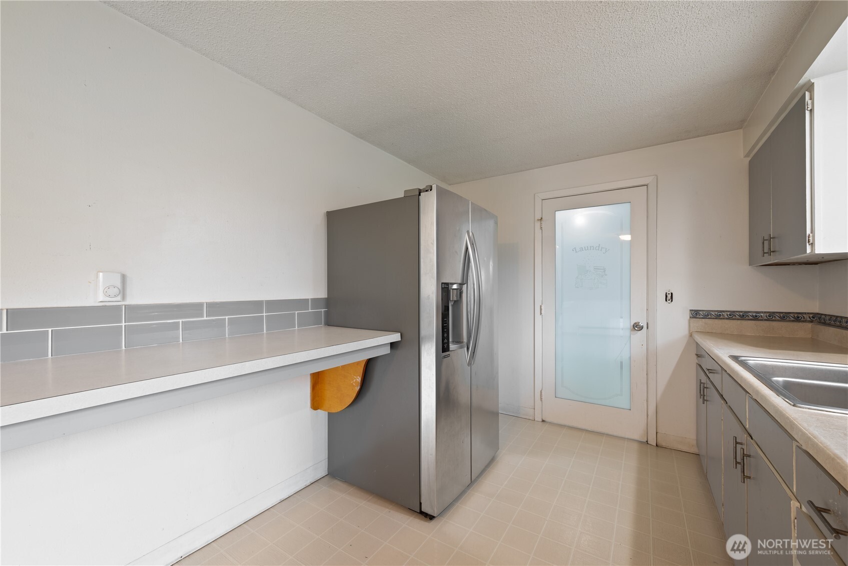 359 Douglas Street Longview, WA 98632 - Photo 15 of 29 a view of cabinets with stainless steel appliances wooden floor and window