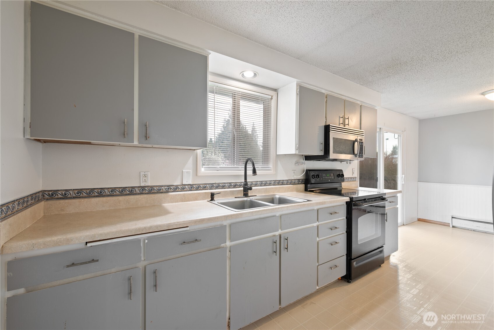 359 Douglas Street Longview, WA 98632 - Photo 16 of 29 a kitchen with a sink cabinets and window
