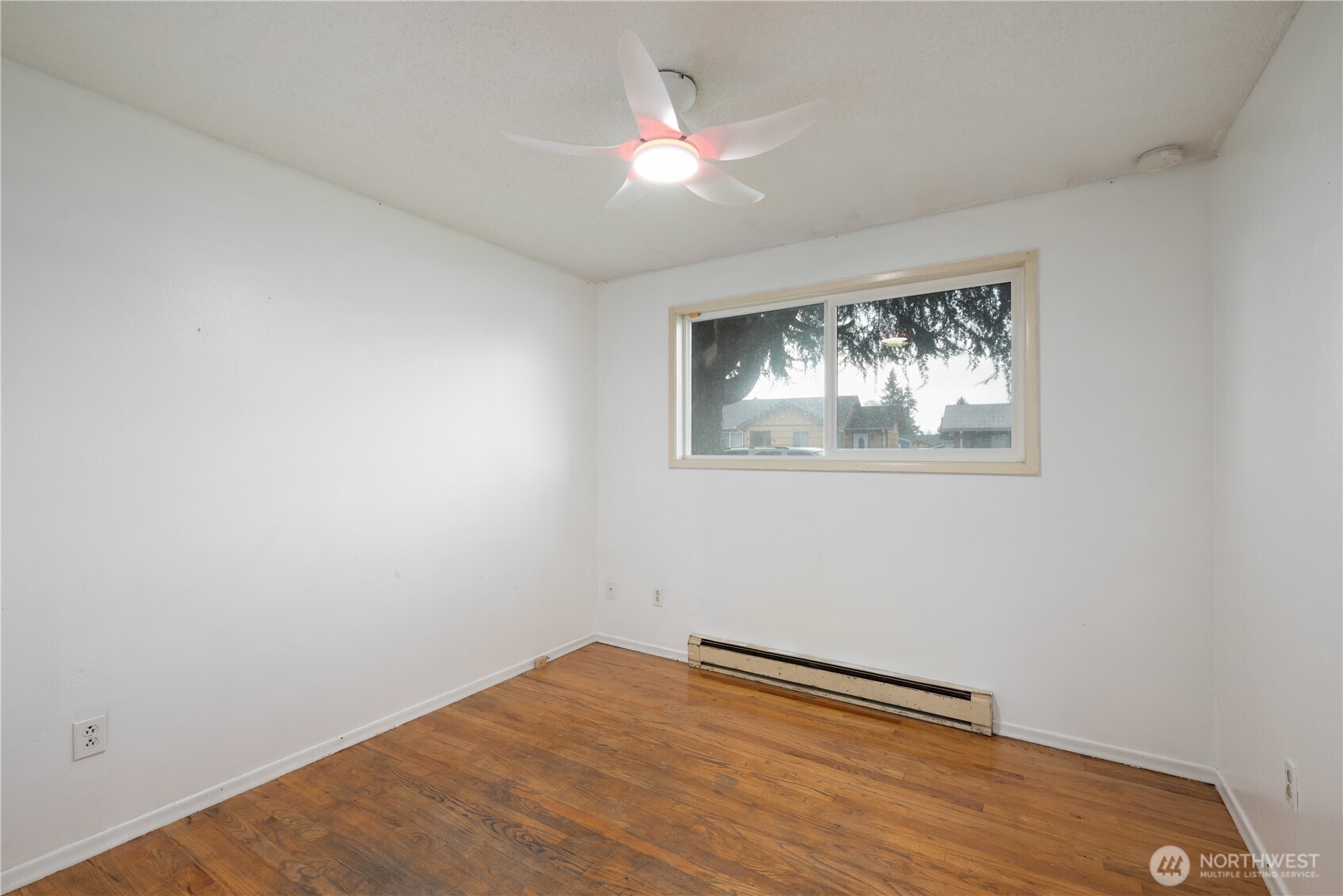 359 Douglas Street Longview, WA 98632 - Photo 18 of 29 a view of empty room with wooden floor and fan