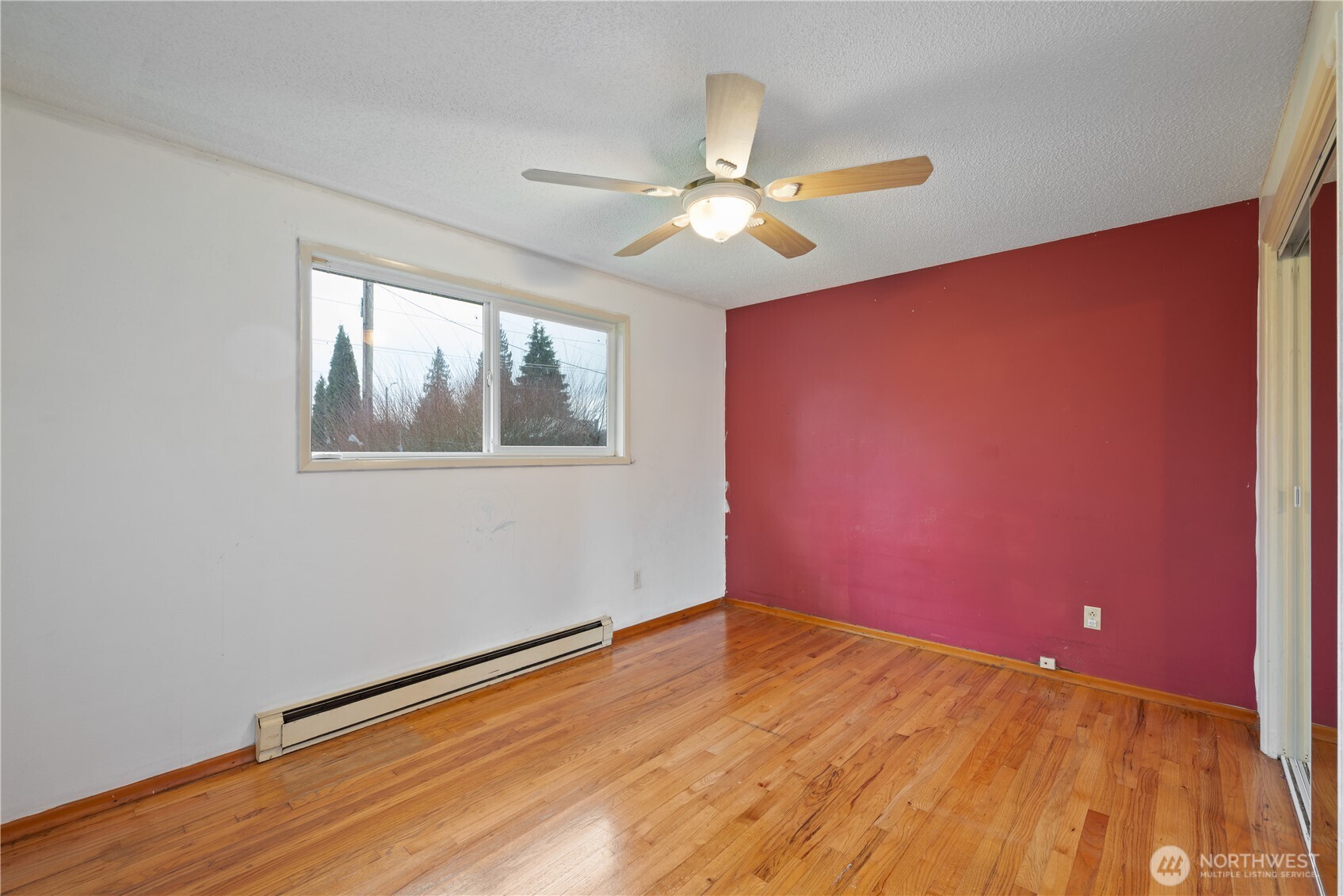 359 Douglas Street Longview, WA 98632 - Photo 20 of 29 a view of empty room with wooden floor and fan