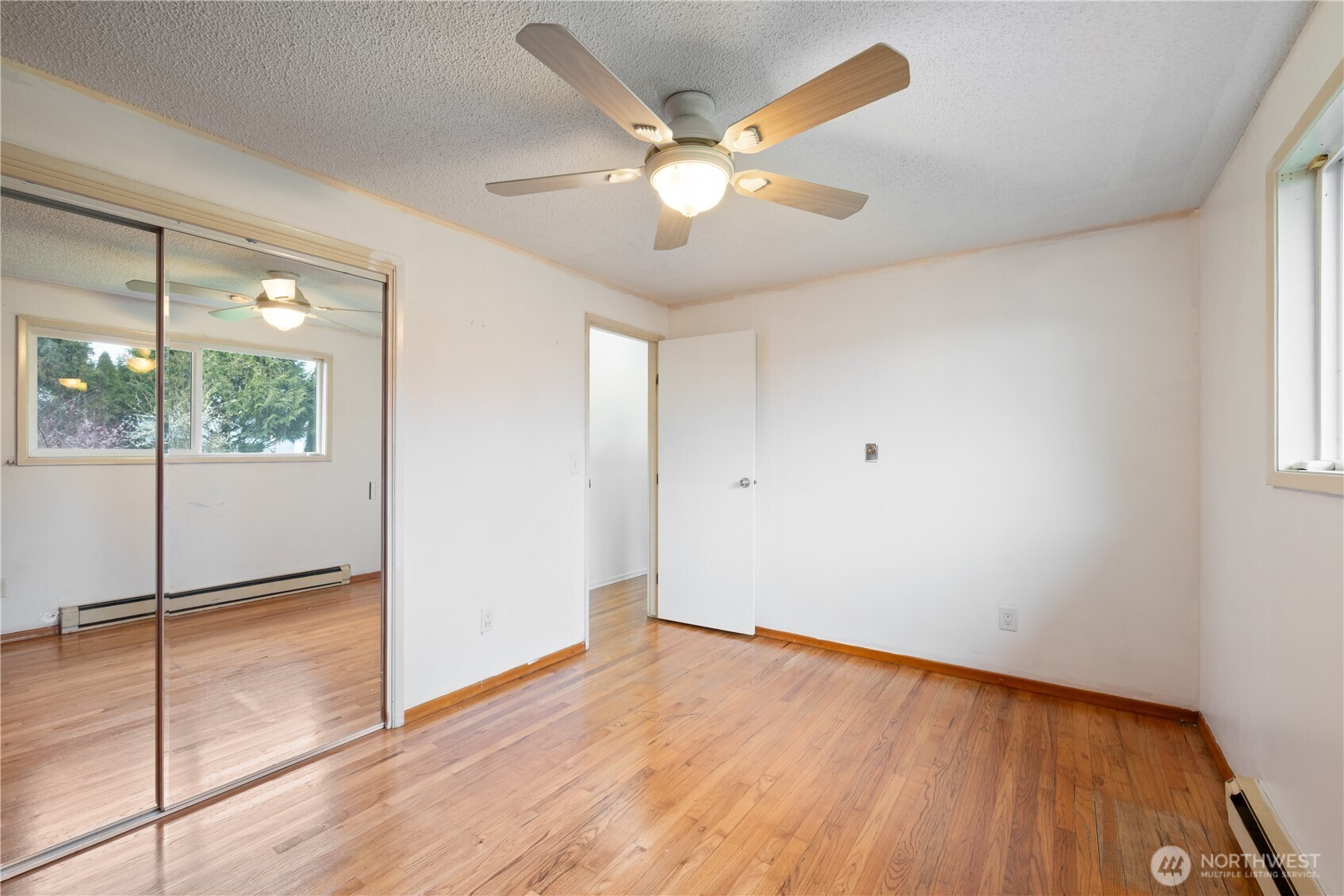 359 Douglas Street Longview, WA 98632 - Photo 21 of 29 a view of an empty room with wooden floor and a window