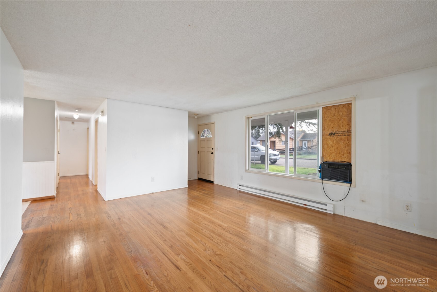359 Douglas Street Longview, WA 98632 - Photo 7 of 29 a view of an empty room with wooden floor and a window