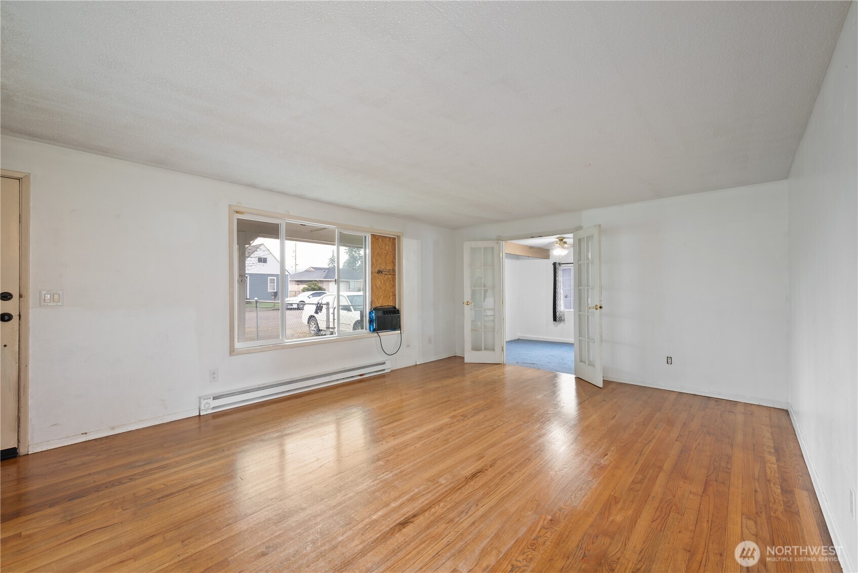 359 Douglas Street Longview, WA 98632 - Photo 8 of 29 an empty room with wooden floor and windows