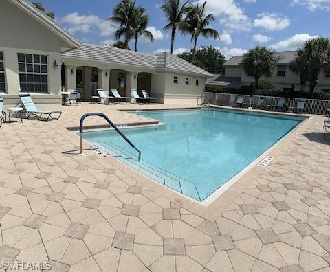 19081 Ridgepoint Drive, Unit 201 Estero, FL 33928 - Photo 35 of 42 a view of a swimming pool with lounge chair