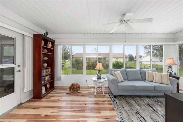 a living room with furniture and a floor to ceiling window