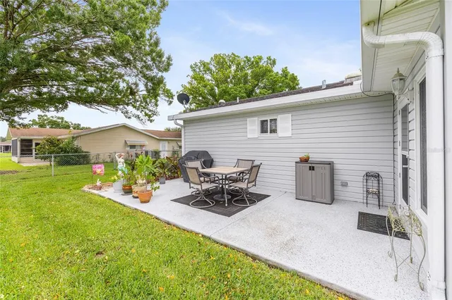 a group of people sitting in front of a house