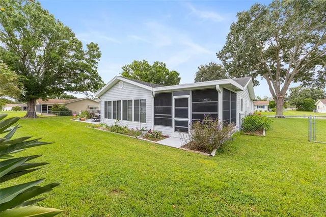 a view of an house with backyard space and balcony