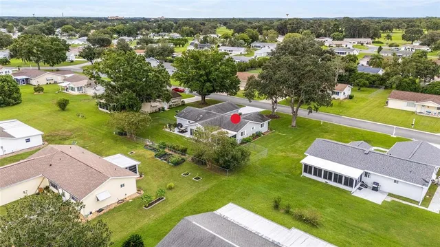 an aerial view of residential houses with outdoor space and swimming pool