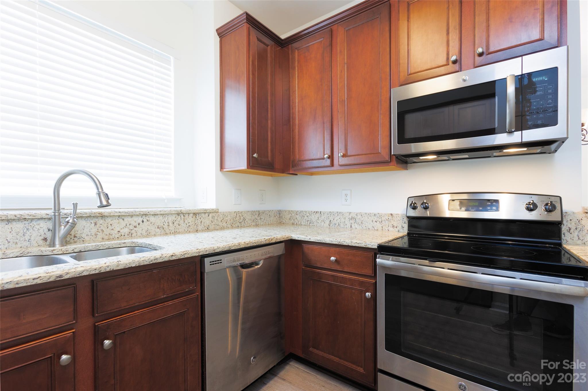 968 Copperstone Lane Fort Mill, SC 29708 - Photo 6 of 13 a kitchen with stainless steel appliances granite countertop a sink stove and microwave