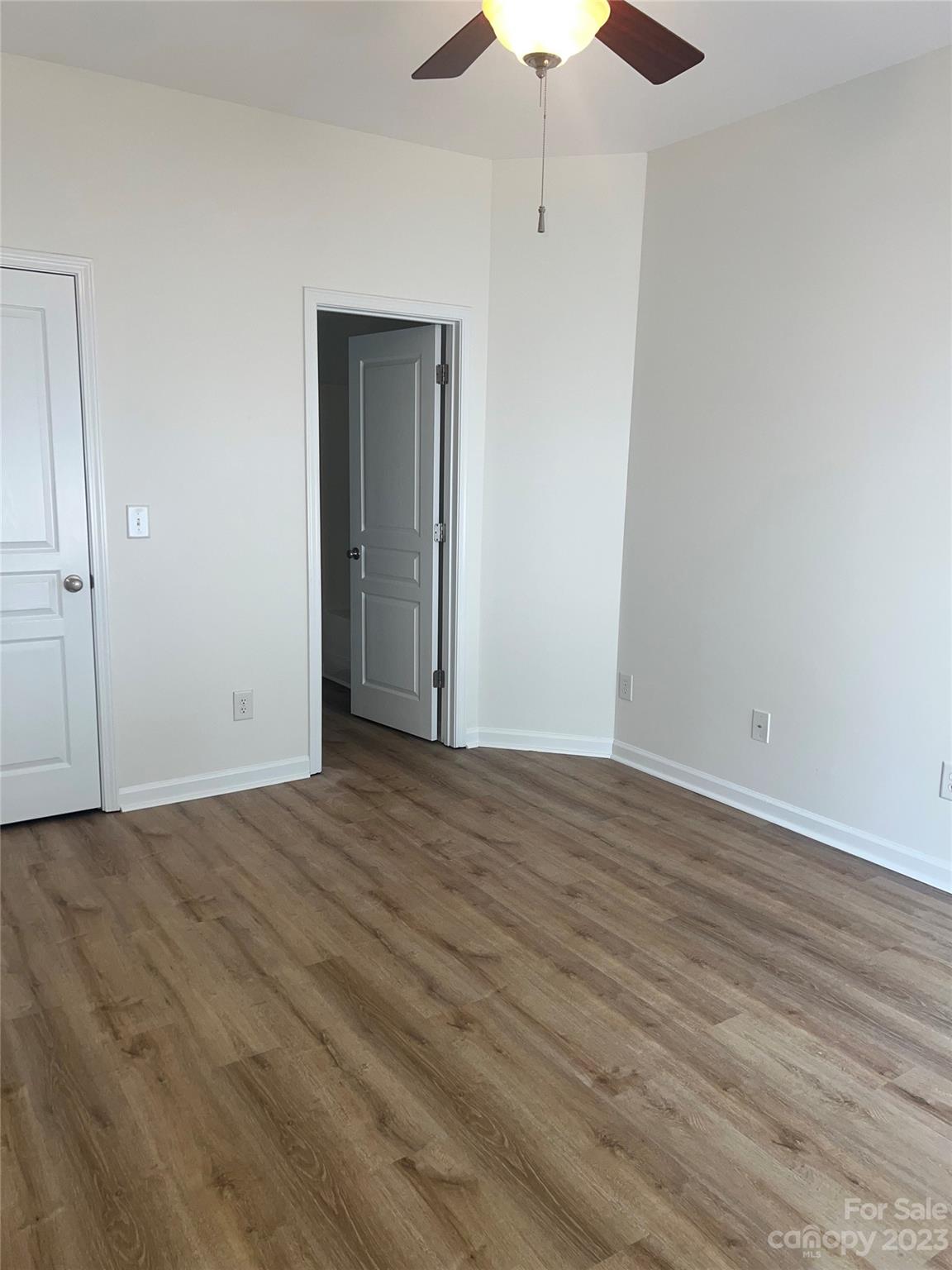 968 Copperstone Lane Fort Mill, SC 29708 - Photo 8 of 13 an empty room with wooden floor chandelier fan and windows