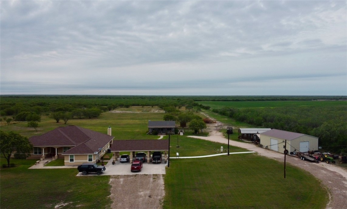 an aerial view of a house with garden space and street view