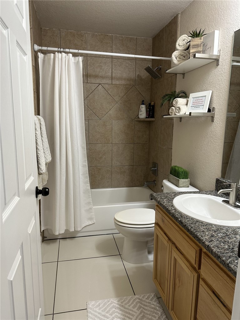 527 Coyote Ranch Alice, TX 78332 - Photo 12 of 17 a bathroom with a granite countertop sink toilet and shower