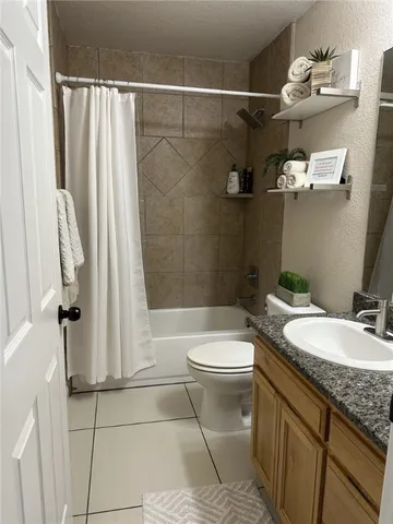 a bathroom with a granite countertop sink mirror vanity and toilet