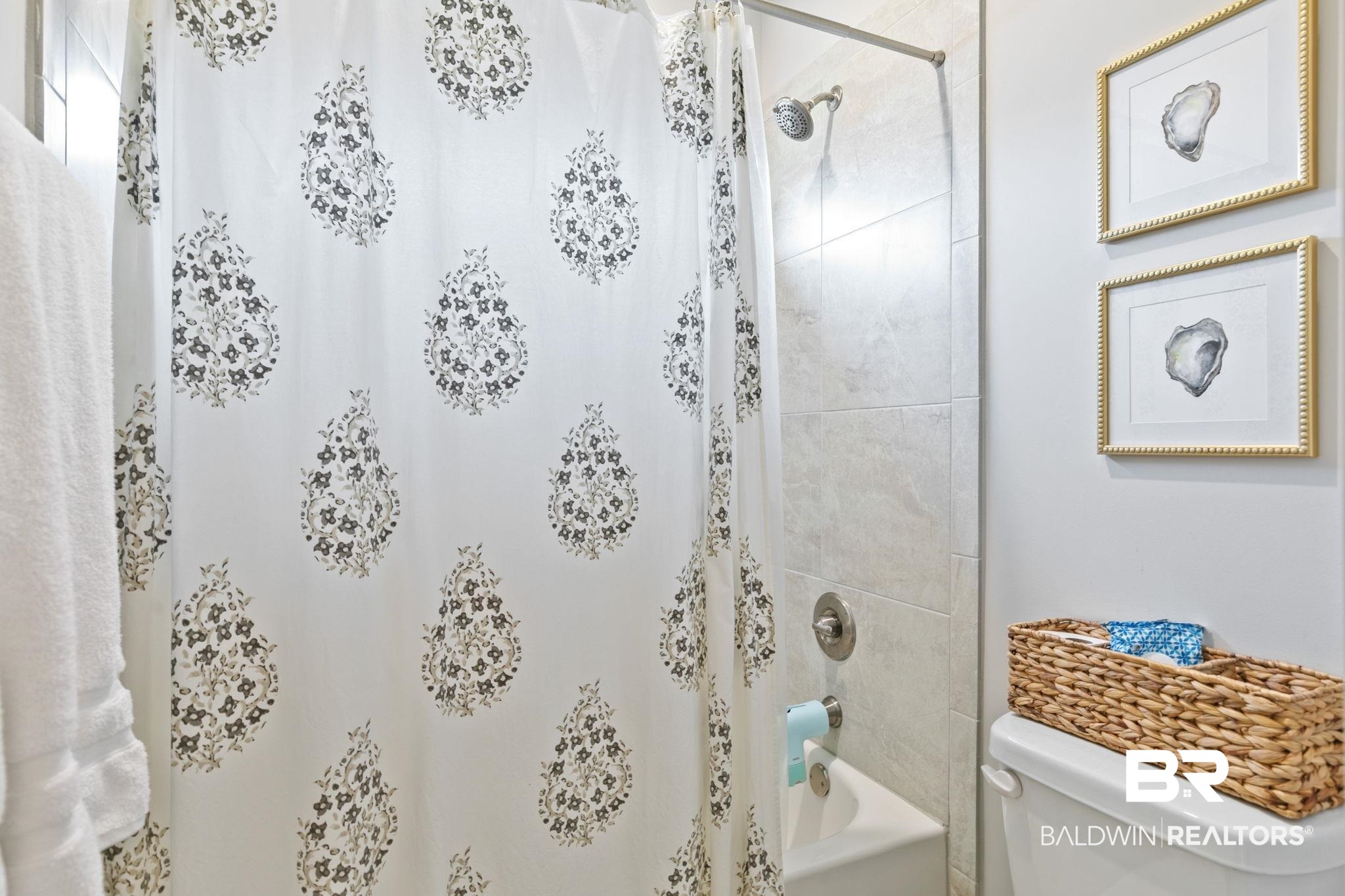 13233 Ibis Boulevard Daphne, AL 36527 - Photo 41 of 100 Tiled shower-tub combination featuring a brushed nickel showerhead and faucet