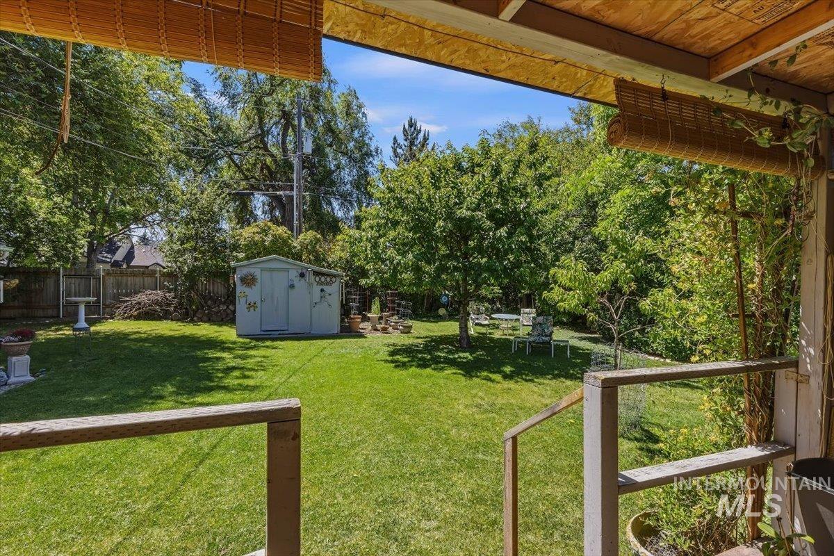 4619 Freemont Street Boise, ID 83706 - Photo 15 of 27 Expansive green lawn with mature trees and a privacy fence