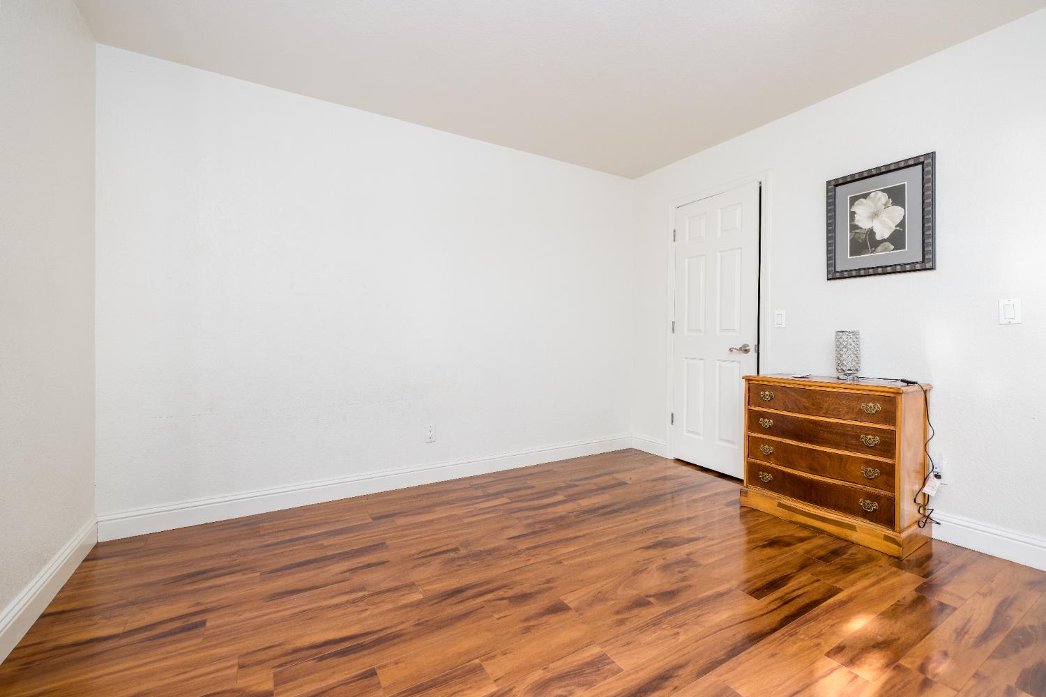 2909 Huntington Boulevard, Unit 133 Fresno, CA 93721 - Photo 11 of 19 a view of empty room with wooden floor and fan