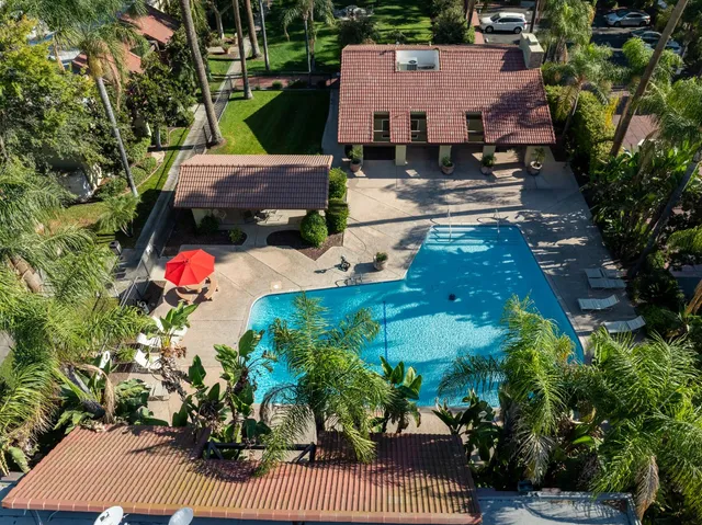 an aerial view of a house with a garden and a fountain