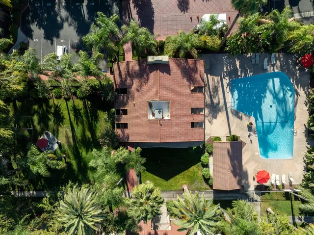 an aerial view of a house with a yard