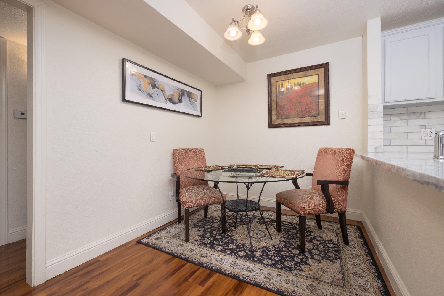 2909 Huntington Boulevard, Unit 133 Fresno, CA 93721 - Photo 5 of 19 a view of a dining room with furniture and wooden floor