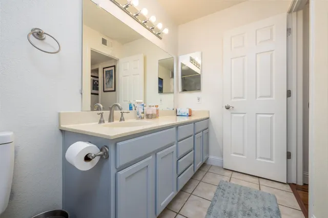 a bathroom with a sink vanity and mirror