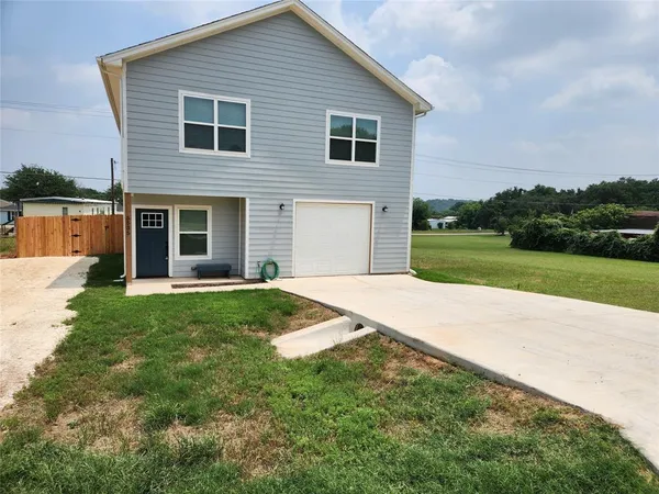 a front view of house with yard and green space