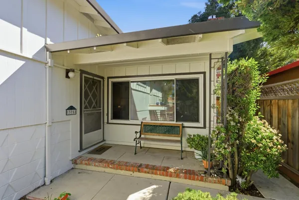a view of house with backyard outdoor seating and shower