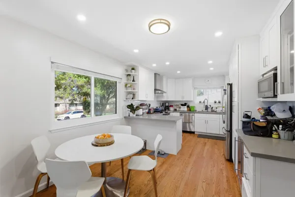 a kitchen with a table and chairs in it