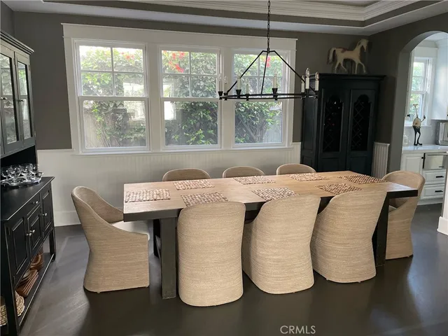 a dining table chair next to a window